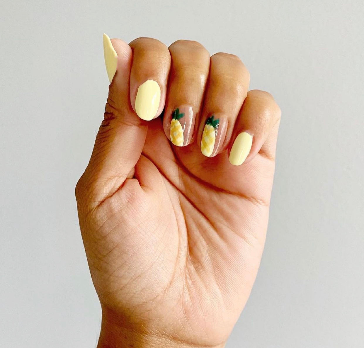 Yellow pineapple nail design. 