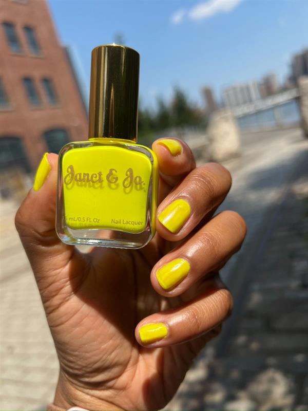 Neon yellow nail design with neon yellow nail polish bottle. 